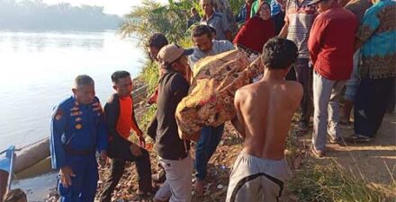 Warga mengevakuasi bocah yang tenggelam.