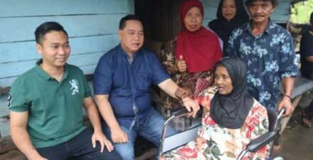 Bupati Halikinnor saat menyerahkan kursi roda kepada warga yang membutuhkannya. (ist)